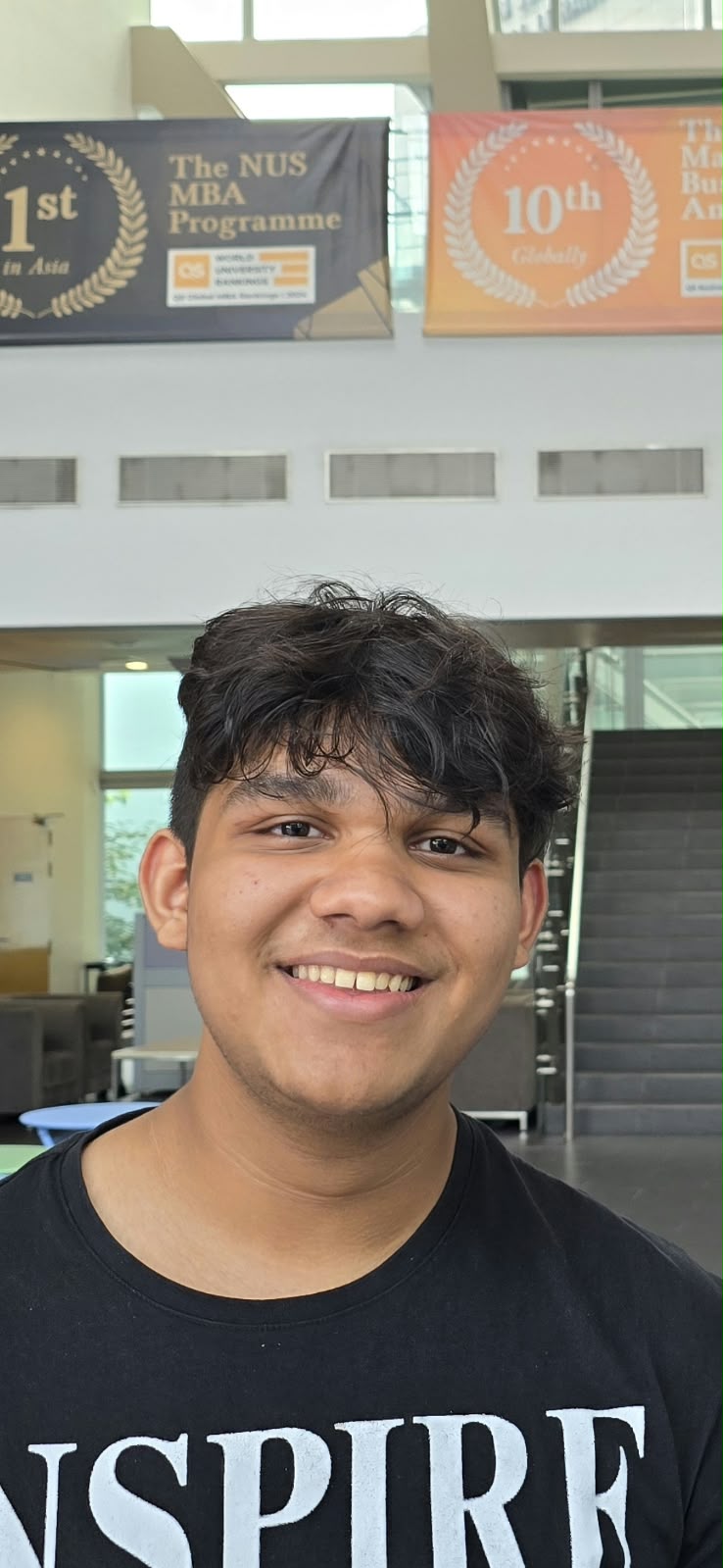 Vivaan at NUS, beneath the NUS MBA Programme banners